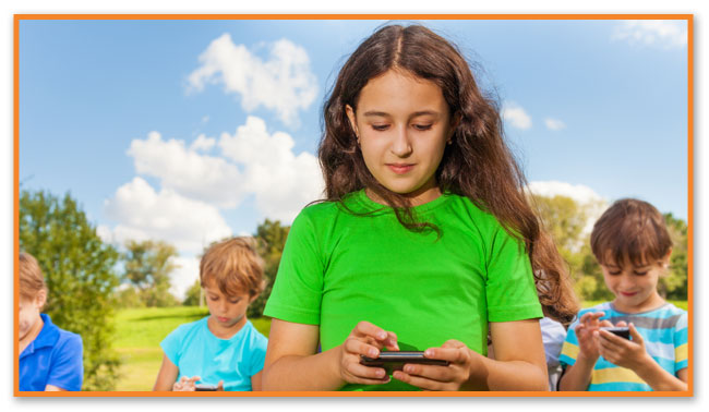 Teenagers on phones at Montclair Pediatric Dental Care Near West Orange